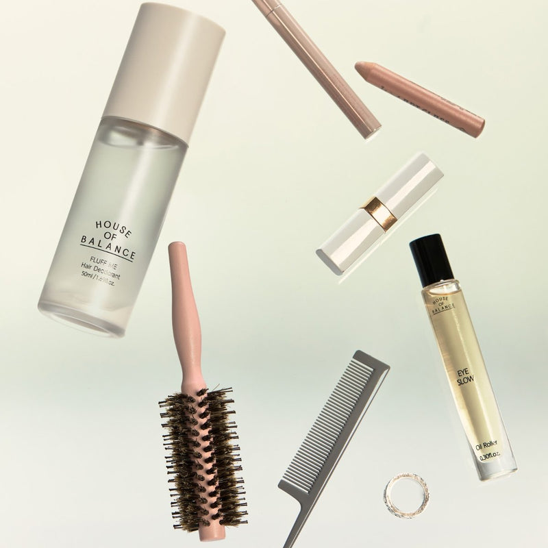 Fluff Me Hair Deodorant with a hairbrush, comb and everyday beauty essentials
